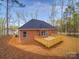 Rear view showcasing a brick house with a newly constructed wooden deck at 725 Granna Ln, Lancaster, SC 29720