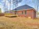 Image displaying a brick home with a wooden deck and a walkout basement entrance at 725 Granna Ln, Lancaster, SC 29720