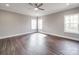 Spacious bedroom with hardwood floors, modern ceiling fan, and natural light from three windows at 725 Granna Ln, Lancaster, SC 29720