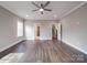 Bedroom with hardwood floors, modern ceiling fan, and two doorways at 725 Granna Ln, Lancaster, SC 29720