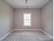 Bright bedroom features a large window, plush carpeting, and neutral paint, creating a cozy atmosphere at 725 Granna Ln, Lancaster, SC 29720