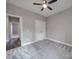 Carpeted bedroom provides ample space, ceiling fan, closet, and bright lighting, ready for customization at 725 Granna Ln, Lancaster, SC 29720