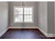 Cozy dining area featuring a window view, wood floors, and a modern chandelier for a warm atmosphere at 725 Granna Ln, Lancaster, SC 29720