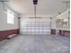 Spacious two-car garage with brick-style bottom walls and natural light, offering room for vehicles and storage at 725 Granna Ln, Lancaster, SC 29720