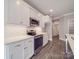 Modern kitchen with stainless appliances, quartz countertops, white cabinets, and an eat-in island at 725 Granna Ln, Lancaster, SC 29720