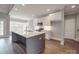Modern kitchen with stainless steel appliances, white cabinets, gray island and stylish lighting at 725 Granna Ln, Lancaster, SC 29720