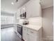 Bright kitchen features white cabinetry, quartz countertops, stainless appliances, and herringbone backsplash at 725 Granna Ln, Lancaster, SC 29720