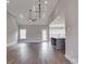 Open-concept living room features hardwood floors, high ceilings, and large windows, with a view of the kitchen island at 725 Granna Ln, Lancaster, SC 29720