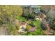 Stunning aerial view of the backyard with lush landscaping and an outdoor fire pit area at 7308 Amberwood Ct, Charlotte, NC 28226