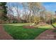 Expansive backyard featuring a lush lawn and mature trees, creating a serene setting at 7308 Amberwood Ct, Charlotte, NC 28226