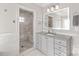 Bright bathroom showcasing a spacious walk-in shower with a bench and neutral vanity at 7308 Amberwood Ct, Charlotte, NC 28226