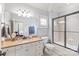 Bright bathroom with a tan granite countertop, tiled floors, and glass shower at 7308 Amberwood Ct, Charlotte, NC 28226