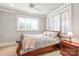 Cozy bedroom with a ceiling fan, two bright windows, and a nightstand at 7308 Amberwood Ct, Charlotte, NC 28226