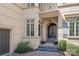 Elegant front entryway with an arched doorway and beautiful wrought iron door at 7308 Amberwood Ct, Charlotte, NC 28226