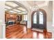 Grand foyer featuring arched entry, ornate iron doors, decorative chandelier and hardwood flooring throughout at 7308 Amberwood Ct, Charlotte, NC 28226