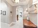 Hallway featuring arches, carpet flooring, decorative sconces, and a wood console table at 7308 Amberwood Ct, Charlotte, NC 28226