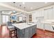Open-concept kitchen with an island, stylish pendant lights, and seamless flow into the living area at 7308 Amberwood Ct, Charlotte, NC 28226