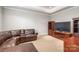 Cozy living room featuring leather furniture, a TV, and a bookcase at 7308 Amberwood Ct, Charlotte, NC 28226