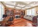 Elegant living room with coffered ceiling, hardwood floors, custom built-ins, fireplace and comfortable seating at 7308 Amberwood Ct, Charlotte, NC 28226