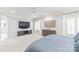 Spacious main bedroom with plush carpet, a large television, and two windows with plantation shutters at 7308 Amberwood Ct, Charlotte, NC 28226