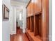 Well-appointed mudroom featuring wooden lockers, drawers, and cherry hardwood flooring at 7308 Amberwood Ct, Charlotte, NC 28226