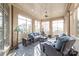 Relaxing sunroom with floor-to-ceiling windows, comfortable seating, and a ceiling fan at 7308 Amberwood Ct, Charlotte, NC 28226