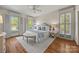 Light-filled bedroom with neutral decor, hardwood floors, and plantation shutters at 7700 Red Oak Ln, Charlotte, NC 28226