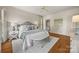Bedroom with neutral decor, hardwood floors, and a sitting bench at 7700 Red Oak Ln, Charlotte, NC 28226