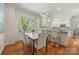View of breakfast nook leading into kitchen with white cabinets and hardwood floors at 7700 Red Oak Ln, Charlotte, NC 28226