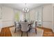 Bright dining room with hardwood floors, chandelier, and views of the yard at 7700 Red Oak Ln, Charlotte, NC 28226