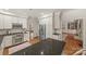 Kitchen with stainless steel appliances, granite countertops, white cabinets, and hardwood floors at 7700 Red Oak Ln, Charlotte, NC 28226