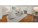Inviting living room featuring hardwood floors, neutral furniture, and natural light at 7700 Red Oak Ln, Charlotte, NC 28226