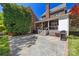 Backyard patio with stone flooring, a built-in grill, and brick accents at 7700 Red Oak Ln, Charlotte, NC 28226