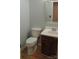 Cozy half bathroom featuring wood-look flooring and a stylish vanity with a framed mirror at 7814 Rolling Meadows Ln, Huntersville, NC 28078