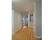 Hallway featuring wood flooring, detailed trim work, with natural light and neutral paint at 7814 Rolling Meadows Ln, Huntersville, NC 28078