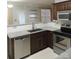 Stylish kitchen with stainless steel appliances, granite countertops, and dark wood cabinets at 7814 Rolling Meadows Ln, Huntersville, NC 28078