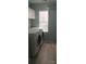 Laundry room with large washer and dryer, overhead cabinets, and natural light at 7814 Rolling Meadows Ln, Huntersville, NC 28078