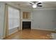 Bright living room featuring a fireplace, modern ceiling fan, and hardwood flooring at 7814 Rolling Meadows Ln, Huntersville, NC 28078