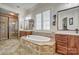 A relaxing bathroom featuring a soaking tub, double vanity, and glass-enclosed shower, perfect for unwinding after a long day at 820 Cooks Cove Rdg, Lake Wylie, SC 29710