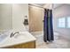 Bathroom featuring tub-shower combo with tile surround and single sink vanity at 820 Cooks Cove Rdg, Lake Wylie, SC 29710