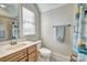 Bright bathroom with window, vanity, toilet, and tiled shower-tub at 820 Cooks Cove Rdg, Lake Wylie, SC 29710