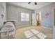 Comfortable carpeted bedroom with neutral paint, bright window, and adjacent bathroom at 820 Cooks Cove Rdg, Lake Wylie, SC 29710