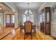 Formal dining room with beautiful hardwood floors, chandelier, and sophisticated decor at 820 Cooks Cove Rdg, Lake Wylie, SC 29710