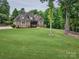 Beautiful brick home with lush lawn, mature trees, and a well-maintained landscape at 820 Cooks Cove Rdg, Lake Wylie, SC 29710