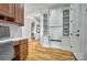 Hallway with a built-in desk area with custom wood cabinets and shelving and hardwood flooring at 820 Cooks Cove Rdg, Lake Wylie, SC 29710