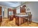 The kitchen features a center island, wooden cabinetry, stainless steel appliances, and quartz countertops at 820 Cooks Cove Rdg, Lake Wylie, SC 29710