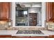 A kitchen cooktop overlooks a stone fireplace and built-in shelving in an adjacent seating area at 820 Cooks Cove Rdg, Lake Wylie, SC 29710
