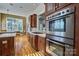 A modern kitchen with stainless steel appliances, wooden cabinets, gas cooktop, and a nearby dining area at 820 Cooks Cove Rdg, Lake Wylie, SC 29710