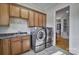 Well-equipped laundry area with modern washer and dryer, sink, and plenty of storage space at 820 Cooks Cove Rdg, Lake Wylie, SC 29710