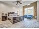 Spacious main bedroom features hardwood floors, a sitting area, and a ceiling fan at 820 Cooks Cove Rdg, Lake Wylie, SC 29710